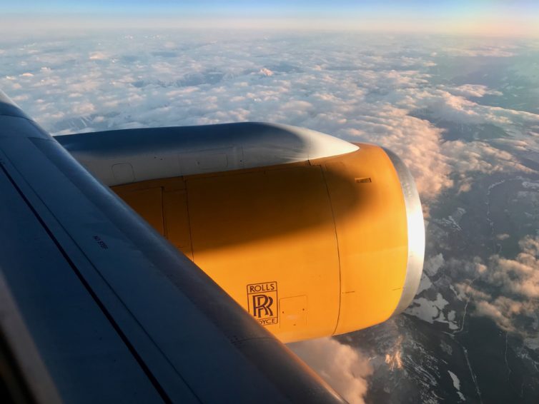 The nose of our 757 shadowing the engine nacelle as we climbed above the clouds. Heading west from Iceland at 5 p.m., we had sunset conditions for the whole flight