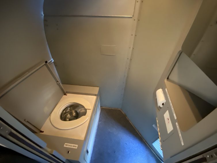 The lavatory in the back of the CMA 1900D. That light on the back wall is coming from the rear cargo area - Photo: Jason Rabinowitz
