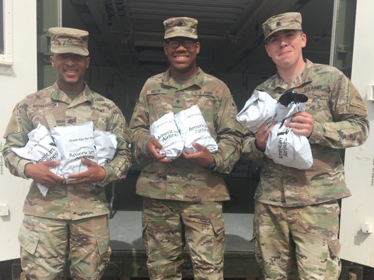 Soldiers receive care packages after arriving on a flight from DFW to ELP