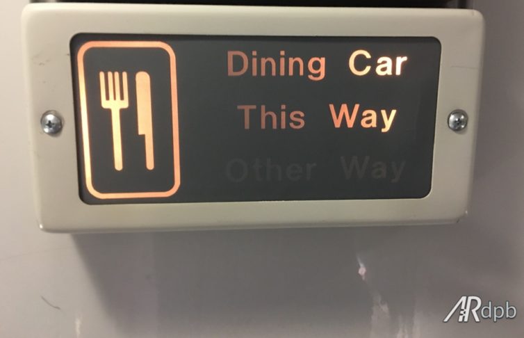 Odd that there is a sign to the dining car. Kind of hard to get lost on the train. 