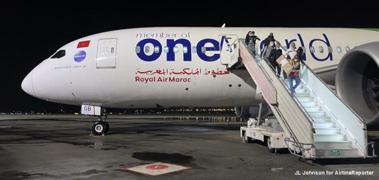 Passengers exit RAM's Oneworld liveried 787-8 on the ramp at Abidjan.