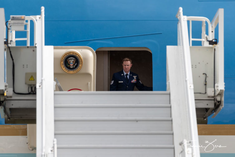 An Air Force officer watches intently as the air stairs are brought up to Air Force One