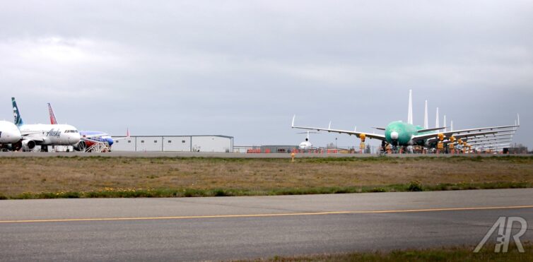 I typically don't like to use two photos that esentially tell the same story, but I like how these other used parked aircraft are watching the new 777s just sitting there. 