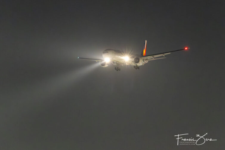 A Starlux Airbus A350 on short final in the nighttime haze