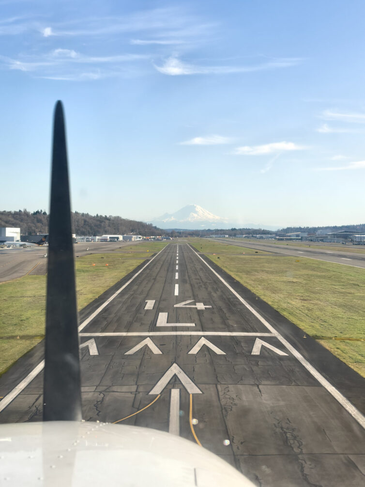 A cockpit view from a Cessna 172 just about to touch down on a runway