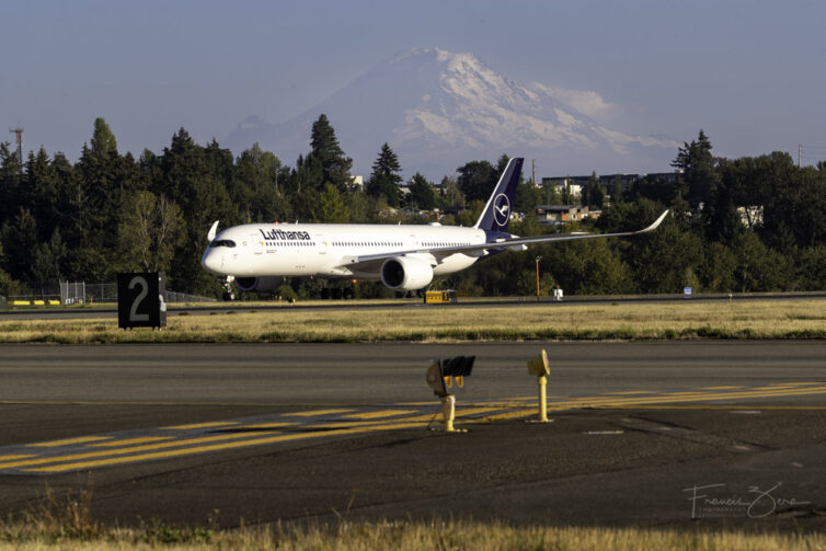 A Lufthansa A350 parked on a ramp at SEA with Mount Rainier visible in the distance